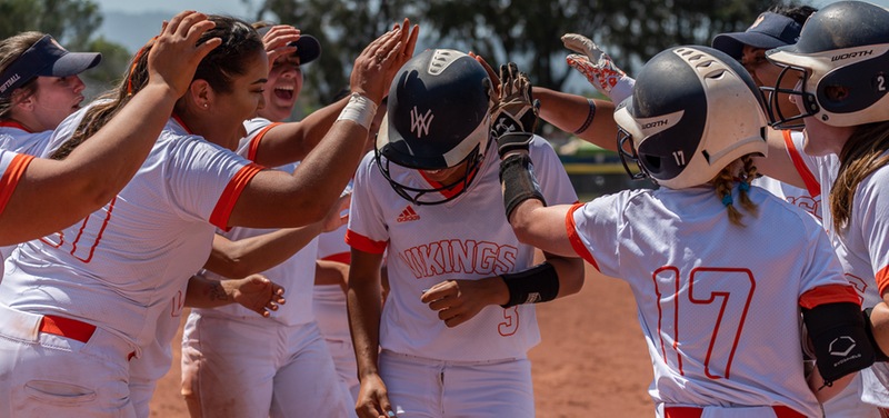 Haley Walker is mobbed by Viking teammates after third-inning homer
